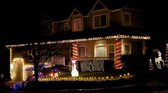 Professionally installed roofline Christmas lights on a Portland home at dusk during the holiday season