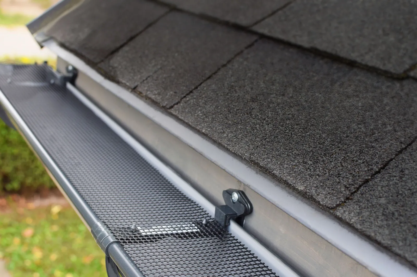 Close-up of micro-mesh gutter guard installed on a Portland home with Douglas fir needles on top