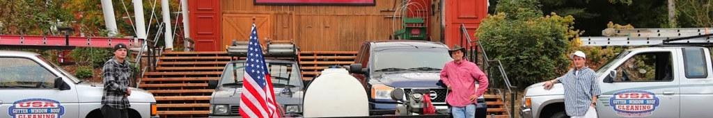 Monte Wallenstein and the USA Gutter crew with branded service trucks and equipment